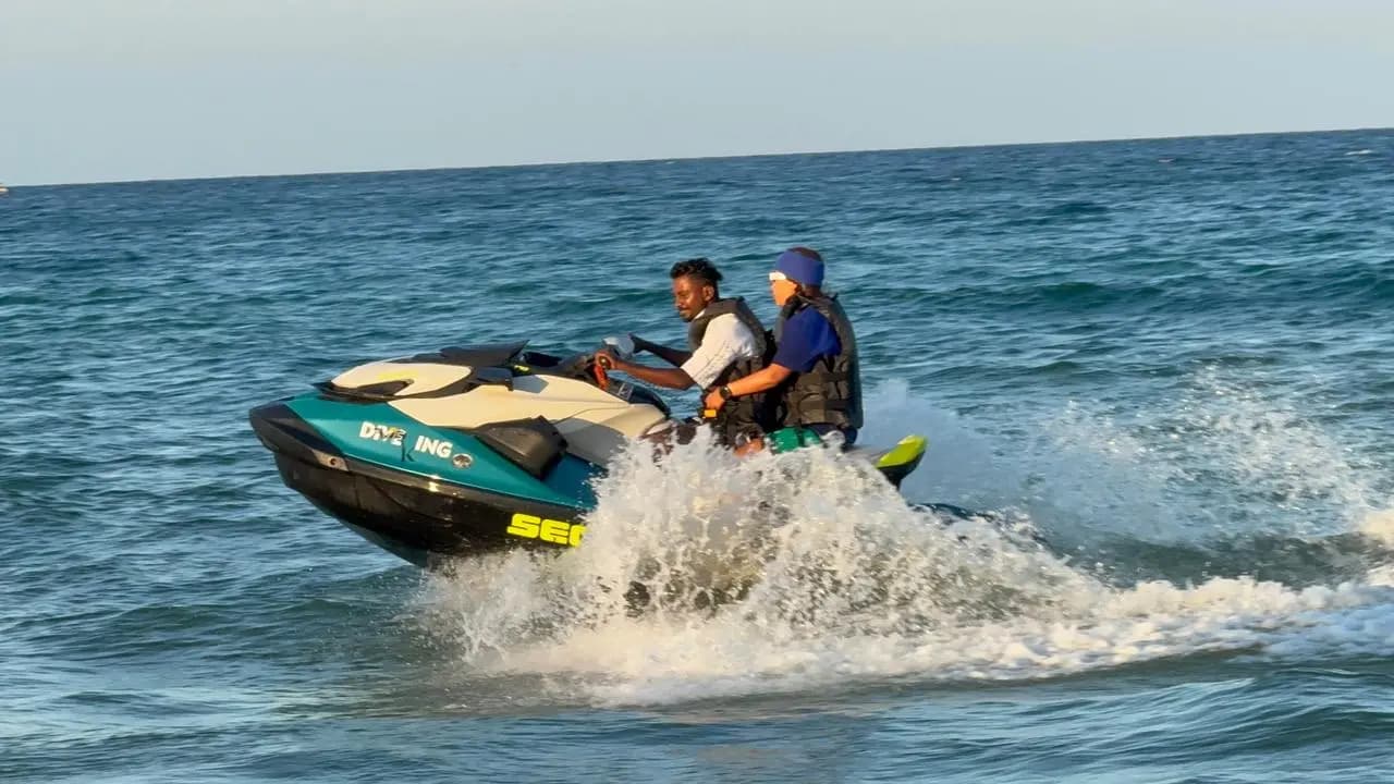 Two riders on a jet ski off the beach in Trincomalee